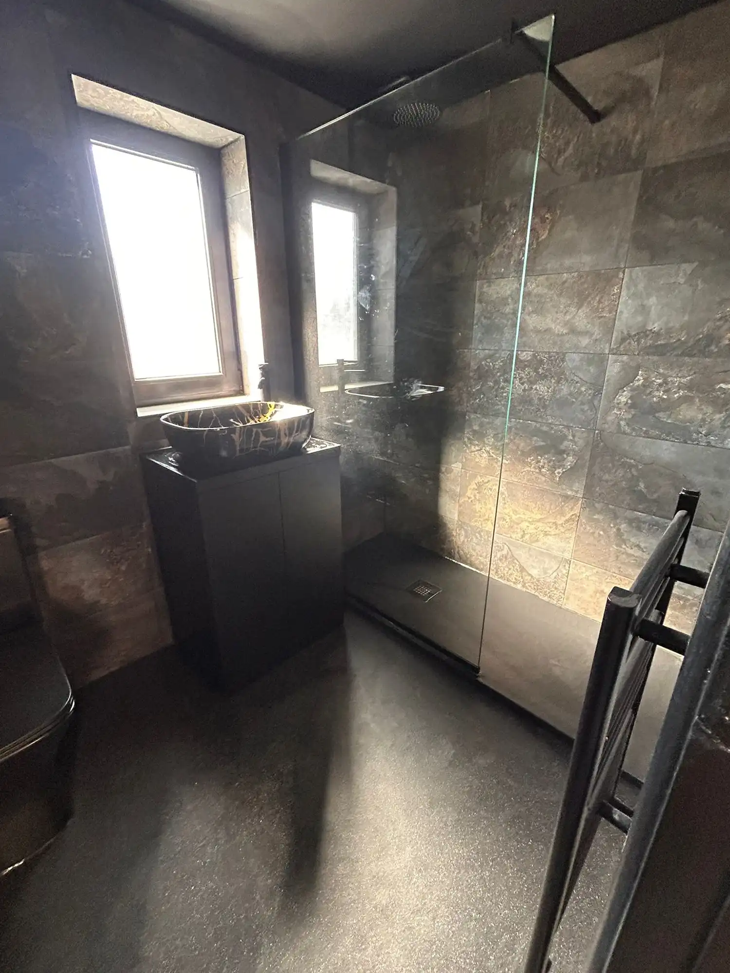 Dark brown tiled bathroom